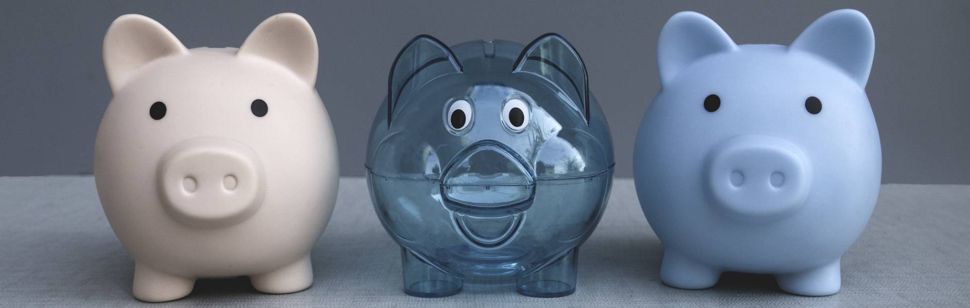 Une image de 3 tirelires de style et de couleur différents.