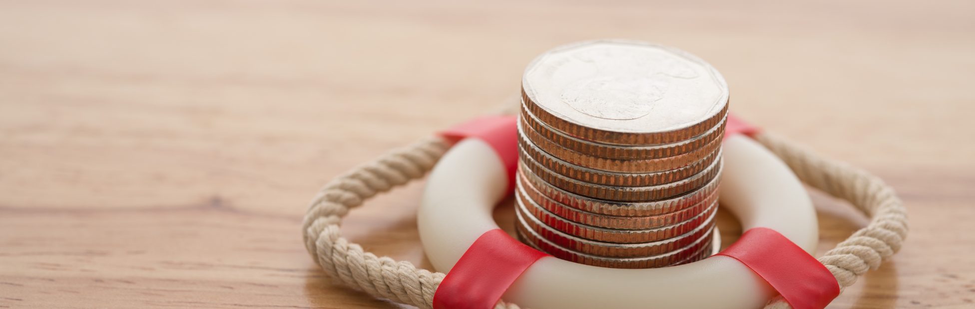 Mini-bouée de sauvetage avec une pile de pièces de monnaie à l'intérieur