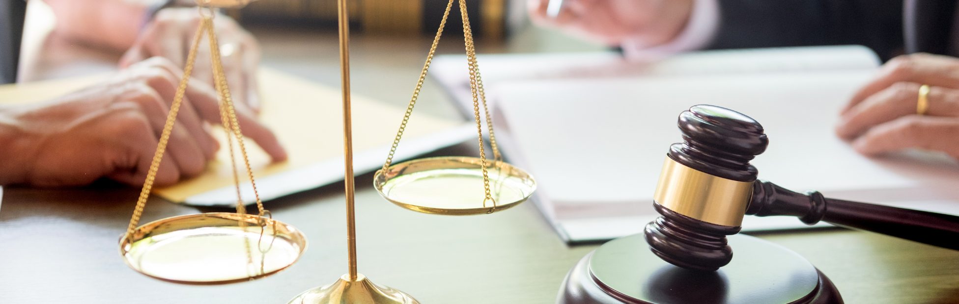 A desk with a gavel and legal paperwork